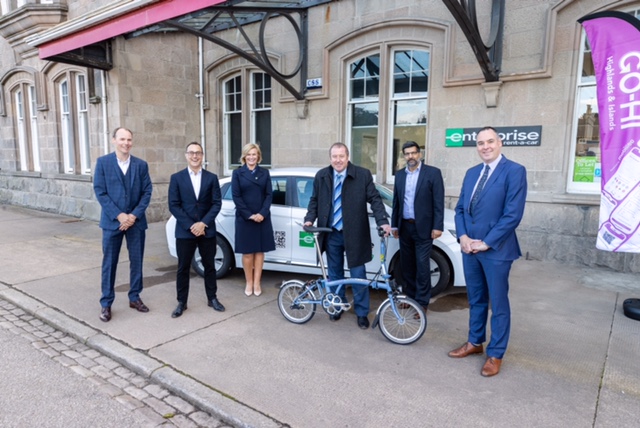 Transport Minister Graeme Dey (holding folding bicycle) is pictured at the Enterprise Office in Elgin where he was given a demonstration of the GO-HI accessibility app.  Pictured with him are (left to right):-Ross Basnett, Strategic Account Director, Mobilleo, Julian Scriven, Managing Director, Brompton Bike Hire, Diane Mulholland, Vice President & General Manager, Scotland, Enterprise Rent-A-Car Oz Choudri, National Marketing Manager, Enterprise Rent-A-Car, Ranald Robertson, Director HITRANS